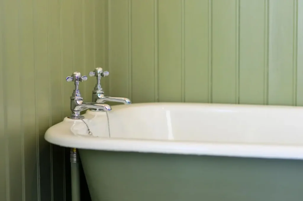 Vintage bathtub with green walls